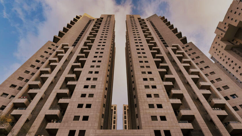 Twin high-rise residential towers in Tel Aviv, Israel, viewed from below against a blue sky